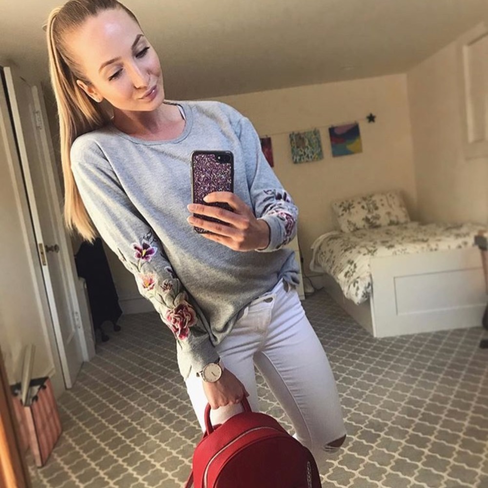 Francisca’s sweatshirt with flowers on sleeves